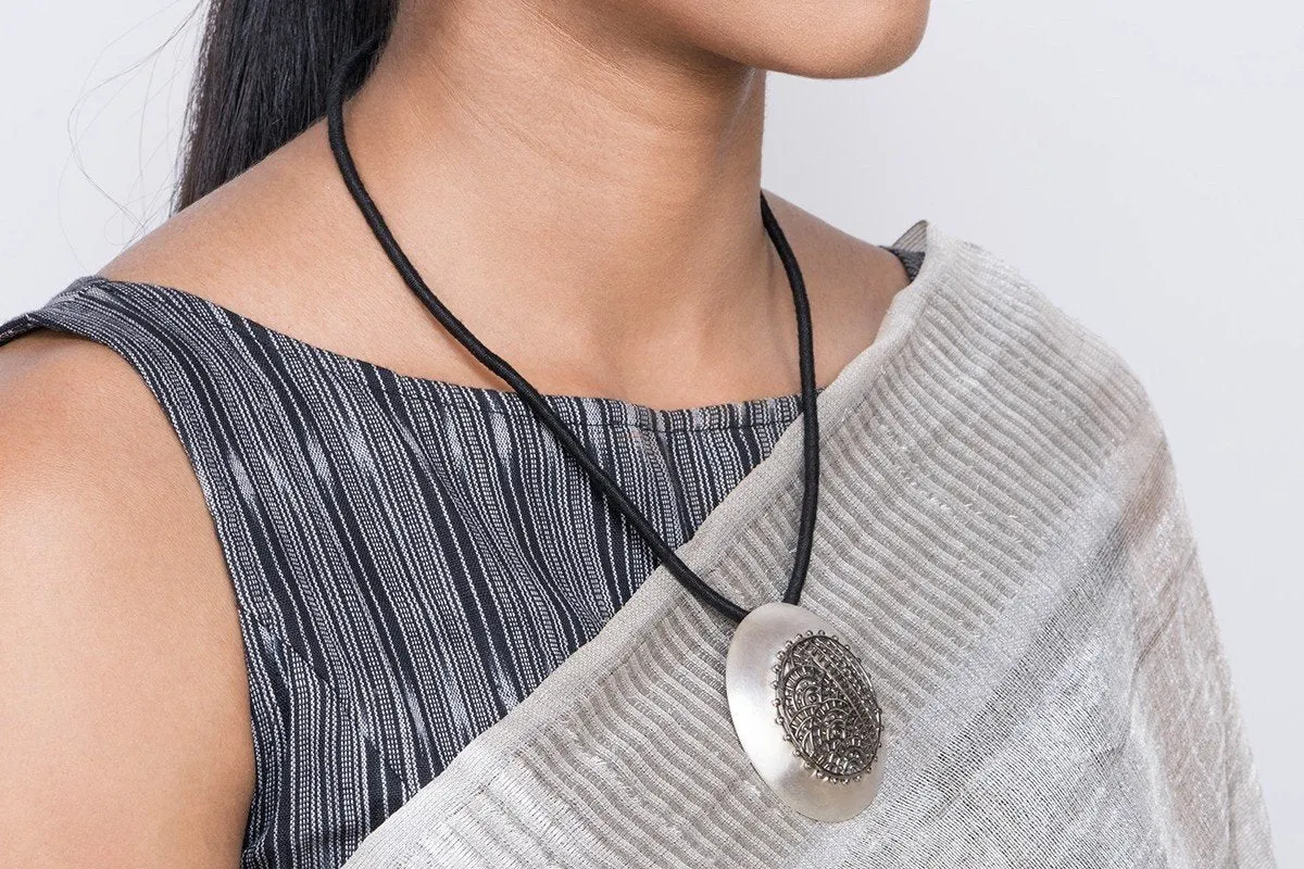 Dramatic, big round pendant with black rhodium plated mehndi-inspired center