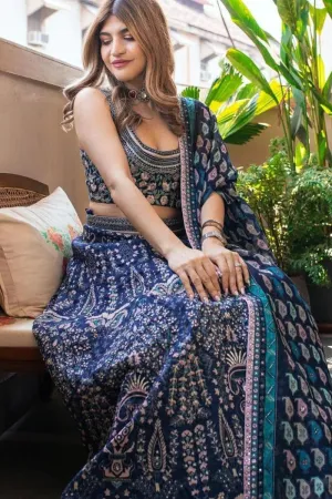 FLORAL EMBELLISHED BLOUSE PAIRED WITH PRINTED LEHENGA WITH SUBLTE EMBELLISHMENTS AND KAIRI PRINTED ORGANZA DUPATTA AND BELT